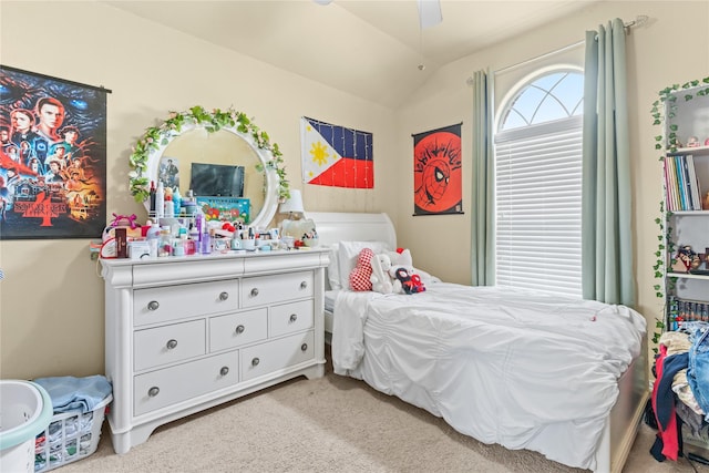bedroom with lofted ceiling, light carpet, and a ceiling fan
