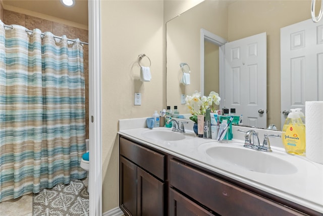 full bathroom featuring tile patterned flooring, double vanity, a sink, and curtained shower
