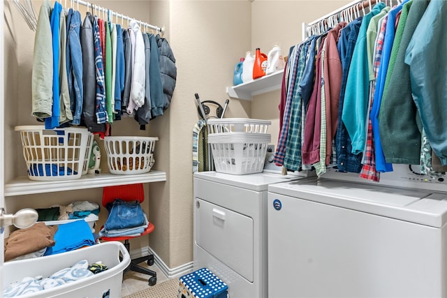 laundry area with laundry area, baseboards, and separate washer and dryer
