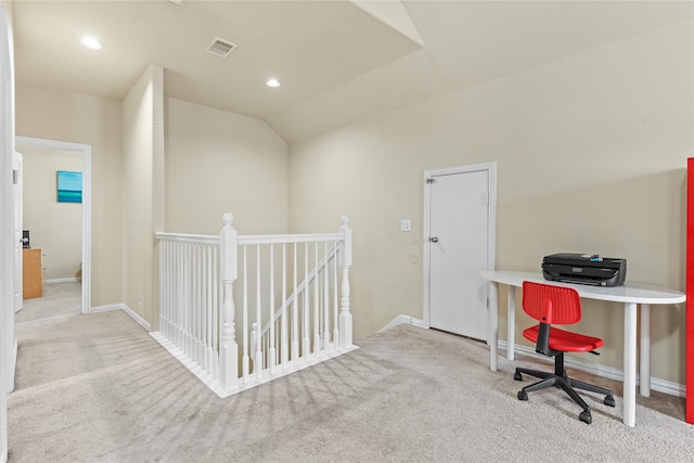 office space featuring carpet flooring, visible vents, baseboards, and lofted ceiling