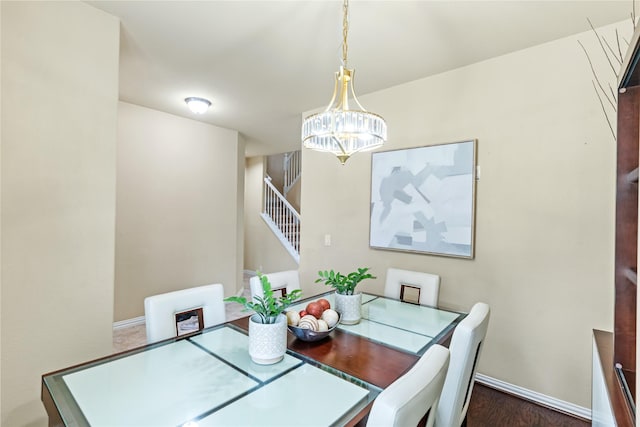 dining room with baseboards, stairway, and an inviting chandelier