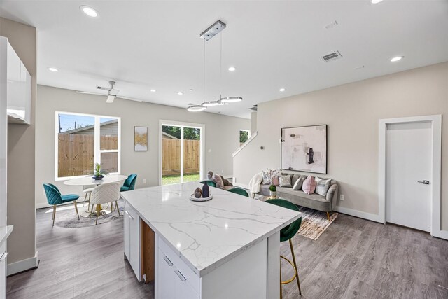 855 Prosper St, Houston, TX 77088 - kitchen featuring light wood finished floors, a center island, open floor plan, visible vents, and recessed lighting
