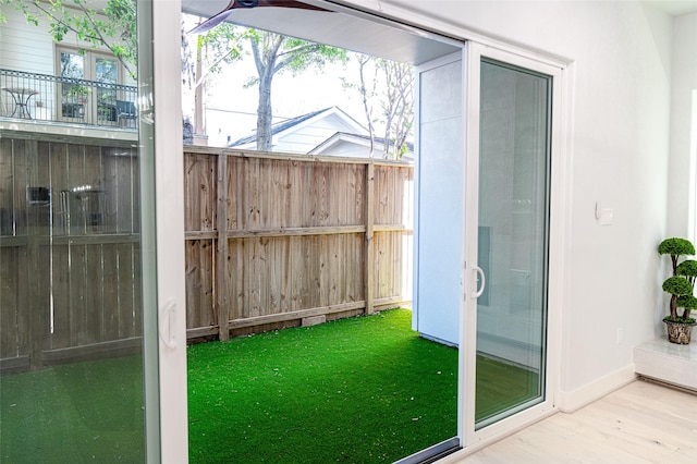 entryway featuring baseboards, wood finished floors, and healthy amount of natural light