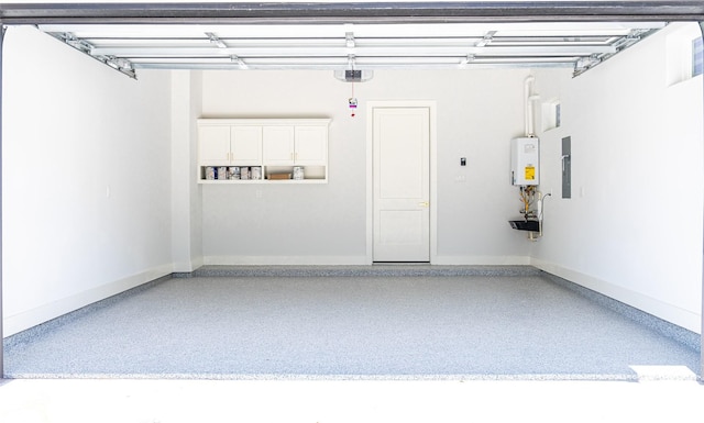 garage featuring a garage door opener, water heater, and baseboards