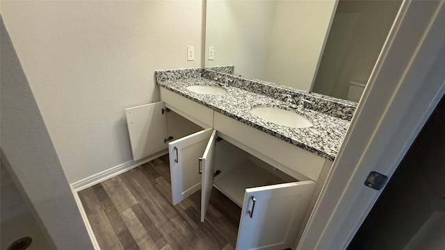 117 Avalon Dr, Huntsville, TX 77320 - bathroom featuring a sink, double vanity, and wood finished floors
