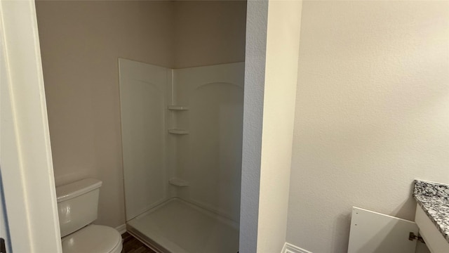 117 Avalon Dr, Huntsville, TX 77320 - full bathroom with toilet, a shower, wood finished floors, vanity, and baseboards