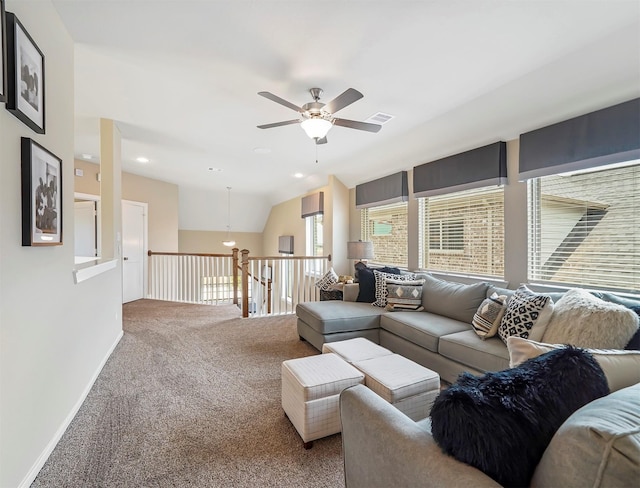 carpeted living area featuring visible vents, baseboards, and a ceiling fan
