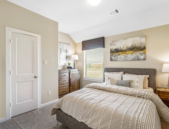 carpeted bedroom with lofted ceiling, baseboards, and visible vents