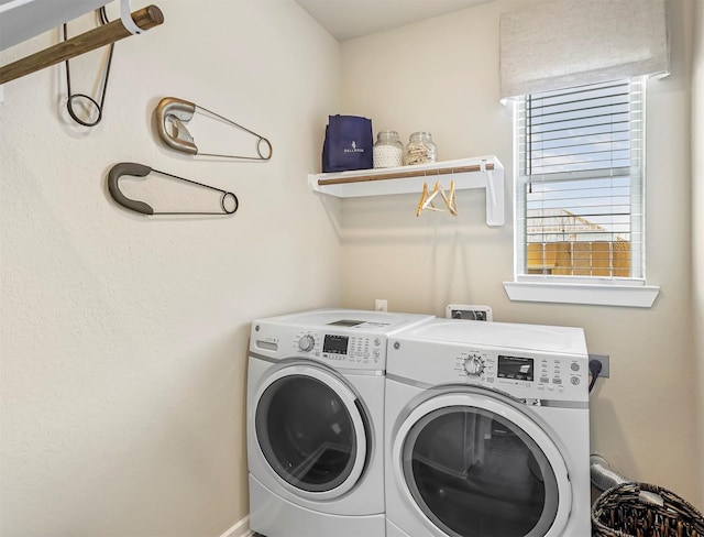 laundry area with washing machine and clothes dryer and laundry area