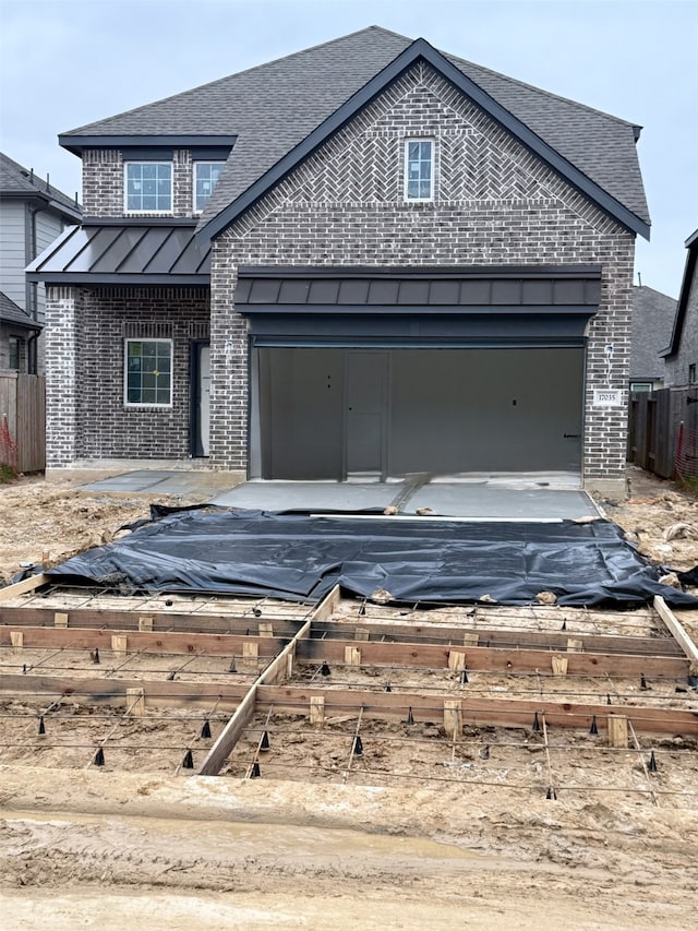 view of front of property with roof with shingles, a standing seam roof, and brick siding