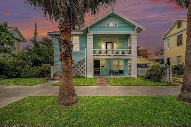 view of front of home featuring a front lawn, a porch, and stairs
