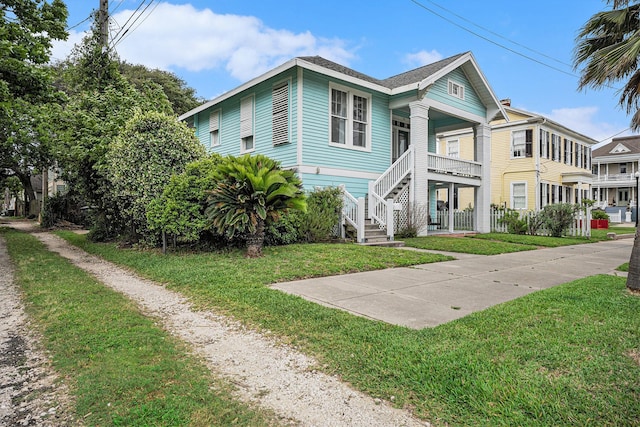 view of front facade with a front yard and stairway