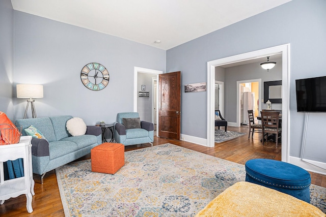 living area with wood finished floors and baseboards