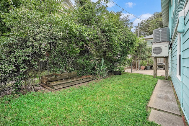 view of yard with ac unit, a patio area, and a garden