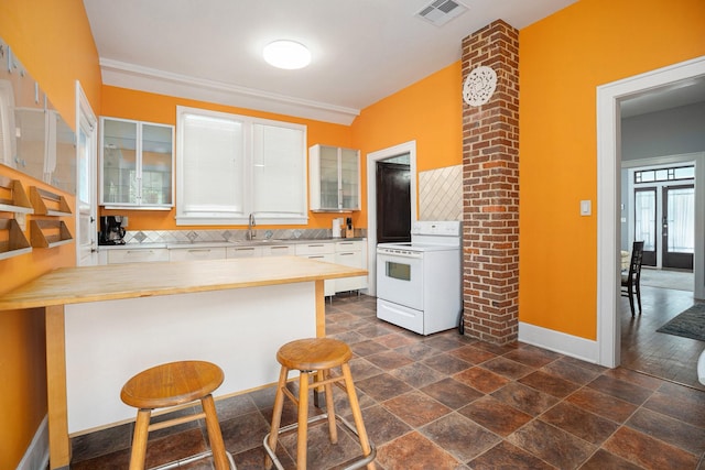 kitchen featuring white electric range oven, glass insert cabinets, baseboards, a sink, and white cabinetry