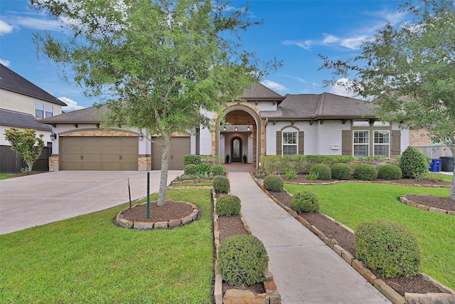 view of front of house featuring concrete driveway, a garage, stucco siding, and a front yard