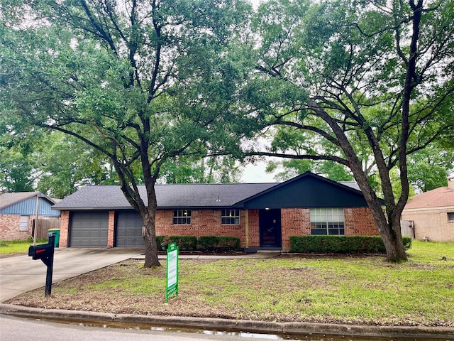 ranch-style home with a front yard, a garage, brick siding, and driveway
