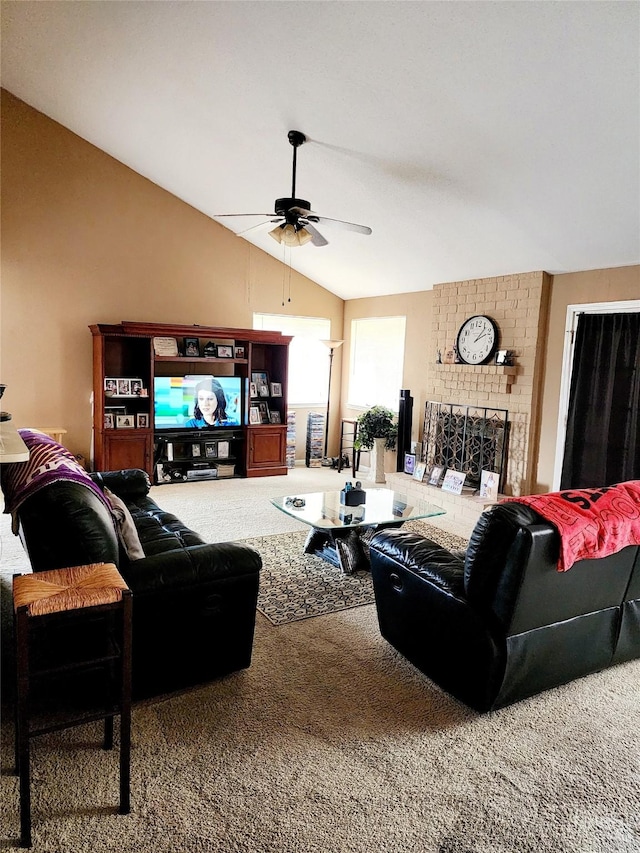 carpeted living area with vaulted ceiling, a fireplace, and ceiling fan