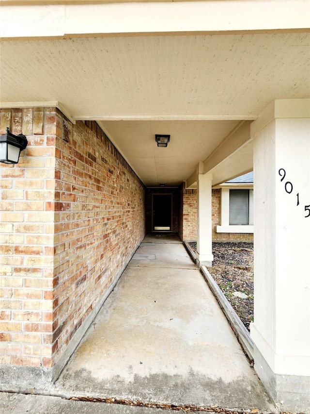 doorway to property featuring brick siding