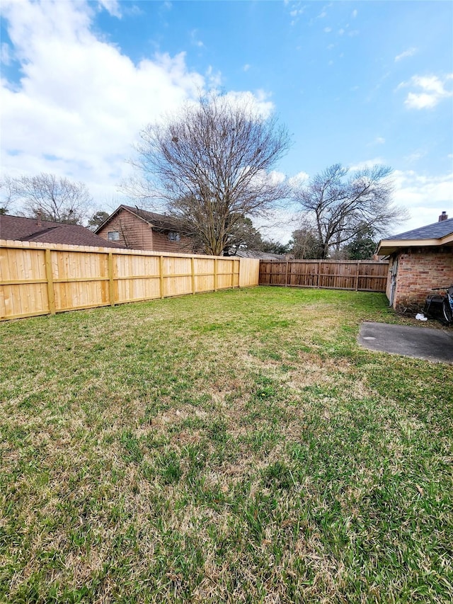 view of yard with a fenced backyard
