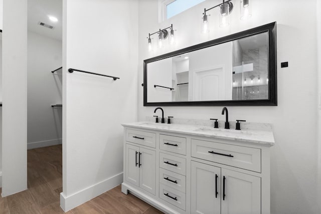 19119 Emory Trl, Spring, TX 77388 - bathroom with baseboards, visible vents, a sink, and wood finished floors
