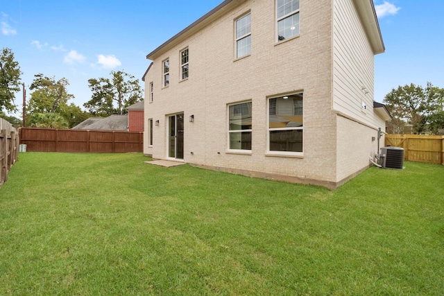 19119 Emory Trl, Spring, TX 77388 - rear view of property with a fenced backyard, brick siding, a yard, and central AC unit