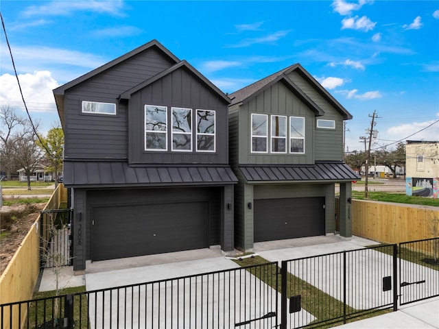 view of front of home featuring an attached garage, metal roof, board and batten siding, driveway, and a standing seam roof