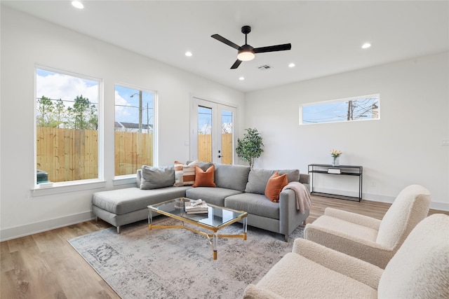 living room with light wood finished floors, visible vents, a ceiling fan, and recessed lighting