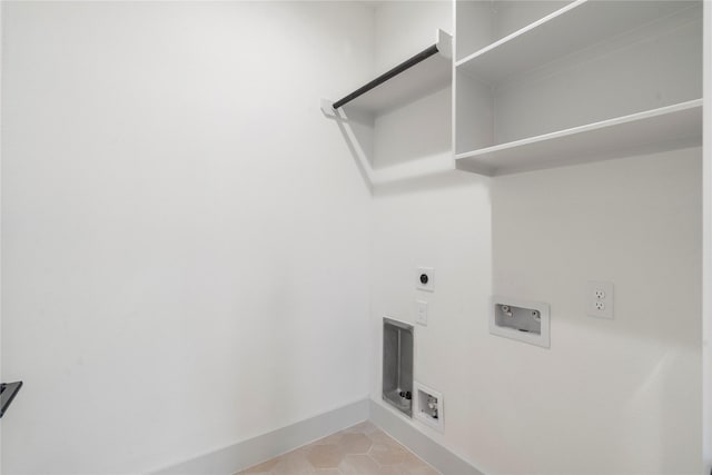 clothes washing area with light tile patterned floors, laundry area, washer hookup, hookup for an electric dryer, and baseboards