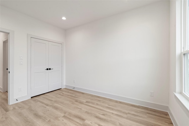 unfurnished bedroom featuring baseboards, recessed lighting, and light wood-type flooring