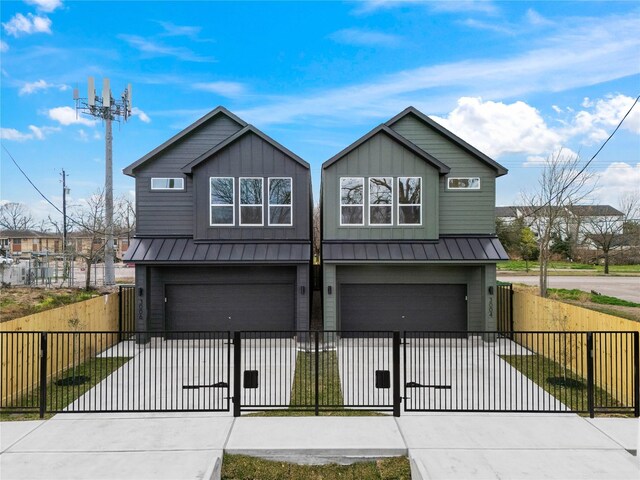 view of front facade featuring concrete driveway, a gate, and a garage