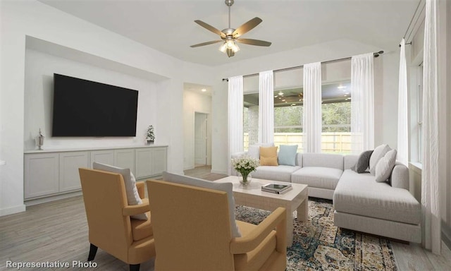 living area with light wood-type flooring, baseboards, and a ceiling fan