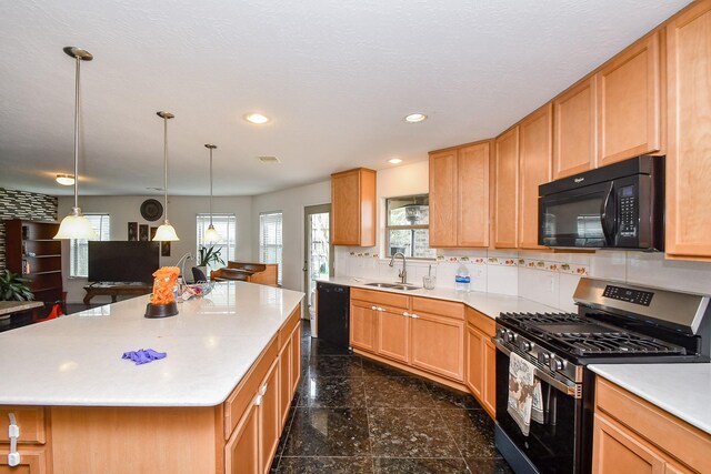 kitchen featuring granite finish floor, a sink, black appliances, light countertops, and recessed lighting
