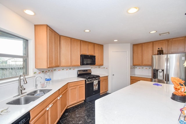 kitchen featuring a sink, black appliances, visible vents, light countertops, and granite finish floor