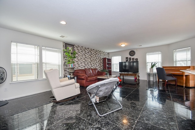 living room featuring recessed lighting, visible vents, baseboards, and granite finish floor