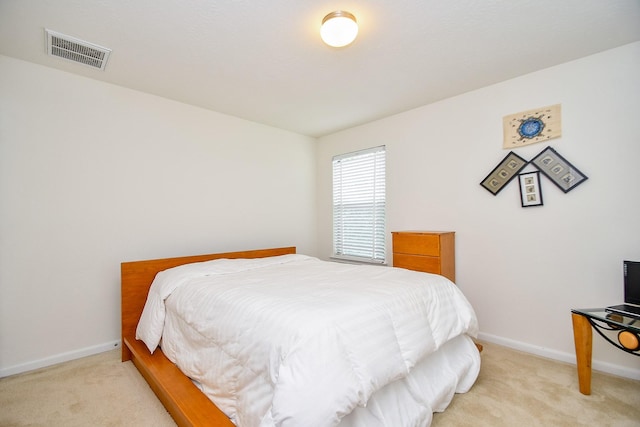 bedroom with light colored carpet, visible vents, and baseboards