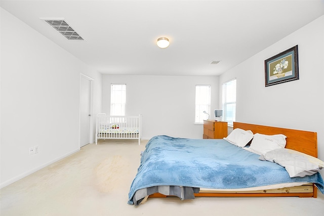 bedroom featuring carpet flooring, visible vents, and baseboards