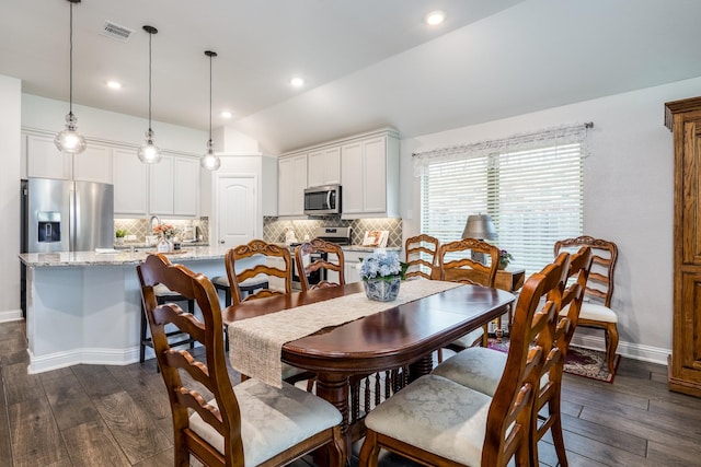 29411 Barker Meadow Ln, Katy, TX 77494 - dining space with lofted ceiling, dark wood-type flooring, baseboards, and recessed lighting