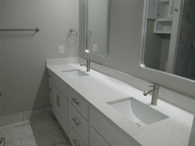 721 E Fayle St, Baytown, TX 77520 - bathroom with double vanity, marble finish floor, and a sink