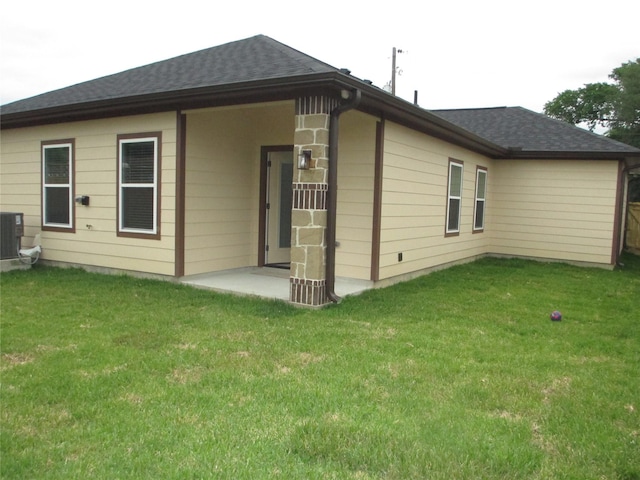 721 E Fayle St, Baytown, TX 77520 - back of property featuring cooling unit, a yard, and roof with shingles