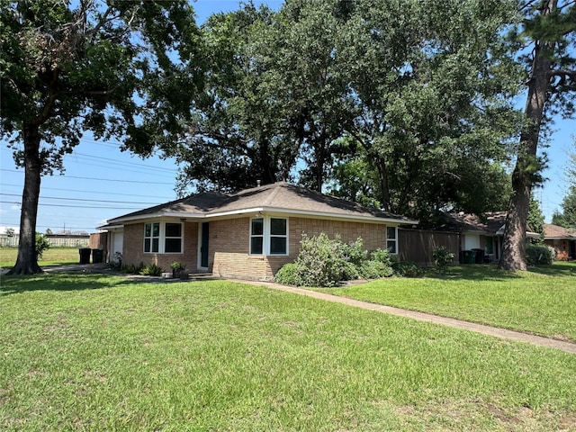 ranch-style house with brick siding and a front lawn