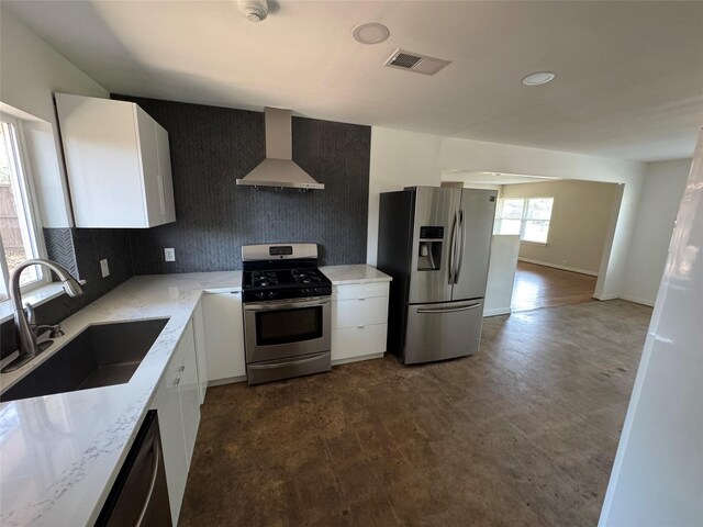 2218 Stonecrest, Houston, TX 77018 - kitchen featuring stainless steel appliances, wall chimney range hood, a sink, and white cabinetry