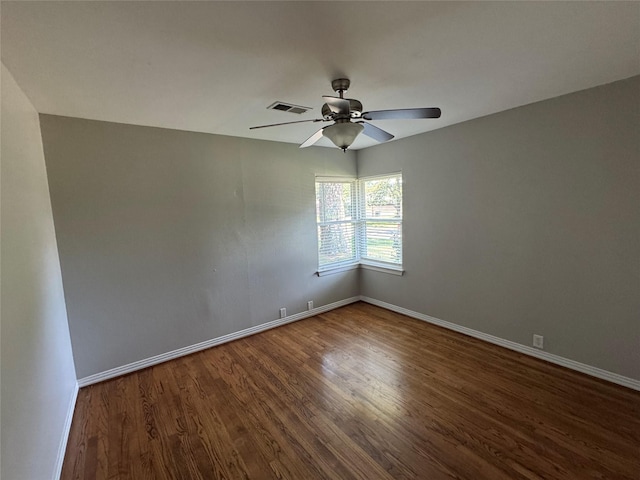 unfurnished room with wood finished floors, baseboards, and a ceiling fan