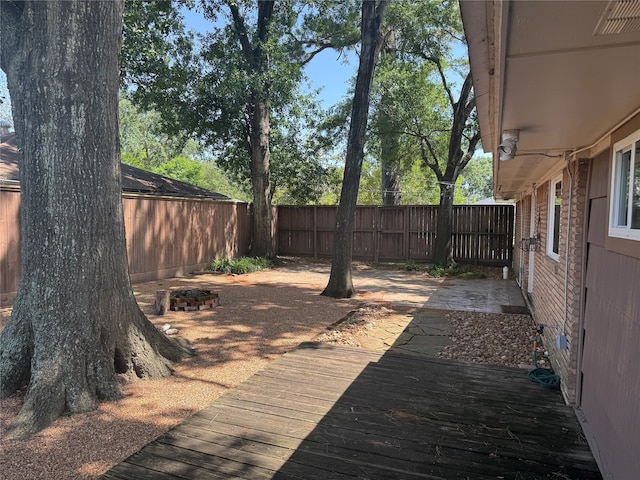 wooden deck featuring a fenced backyard