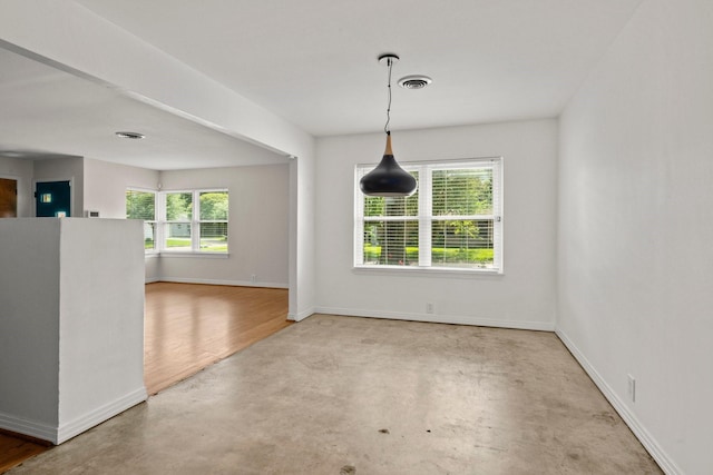 2218 Stonecrest, Houston, TX 77018 - spare room featuring healthy amount of natural light, baseboards, and concrete flooring