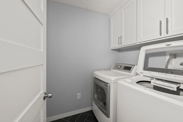 2218 Stonecrest, Houston, TX 77018 - laundry room featuring cabinet space, washer and dryer, dark tile patterned flooring, and baseboards