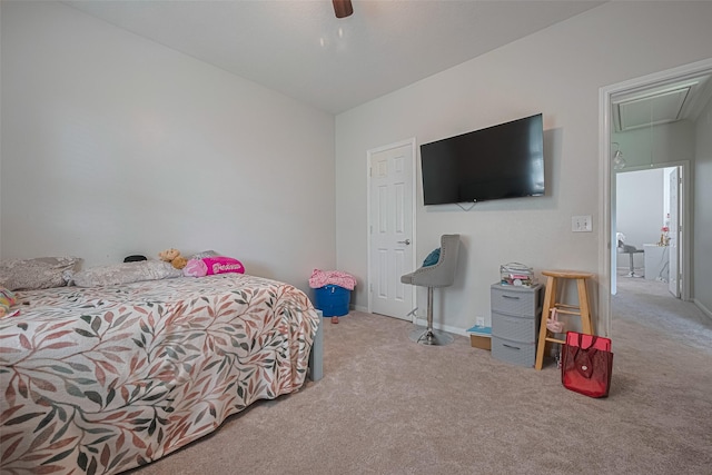 bedroom with ceiling fan, carpet flooring, and attic access
