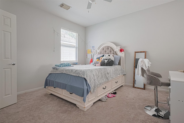 bedroom with light colored carpet, visible vents, baseboards, and ceiling fan