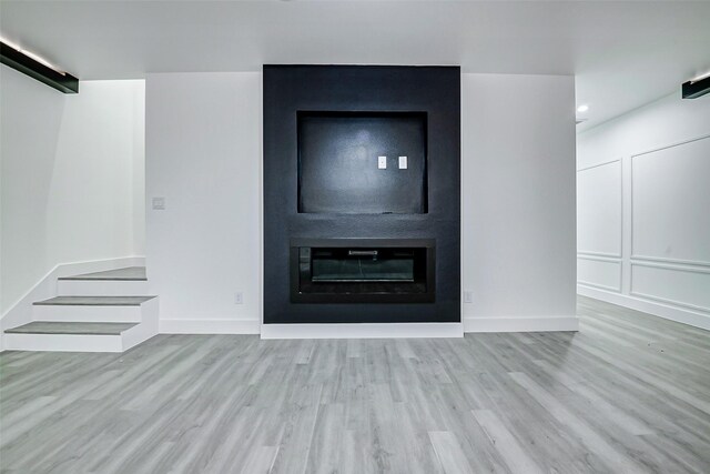 interior space featuring baseboards and wood finished floors