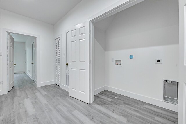 laundry area featuring washer hookup, hookup for an electric dryer, light wood-style flooring, and baseboards